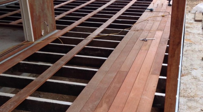 A picture of hardwood decking being laid on hardwood joists