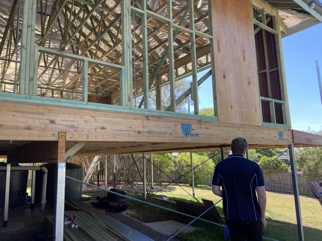 Engineer inspecting timber frame house