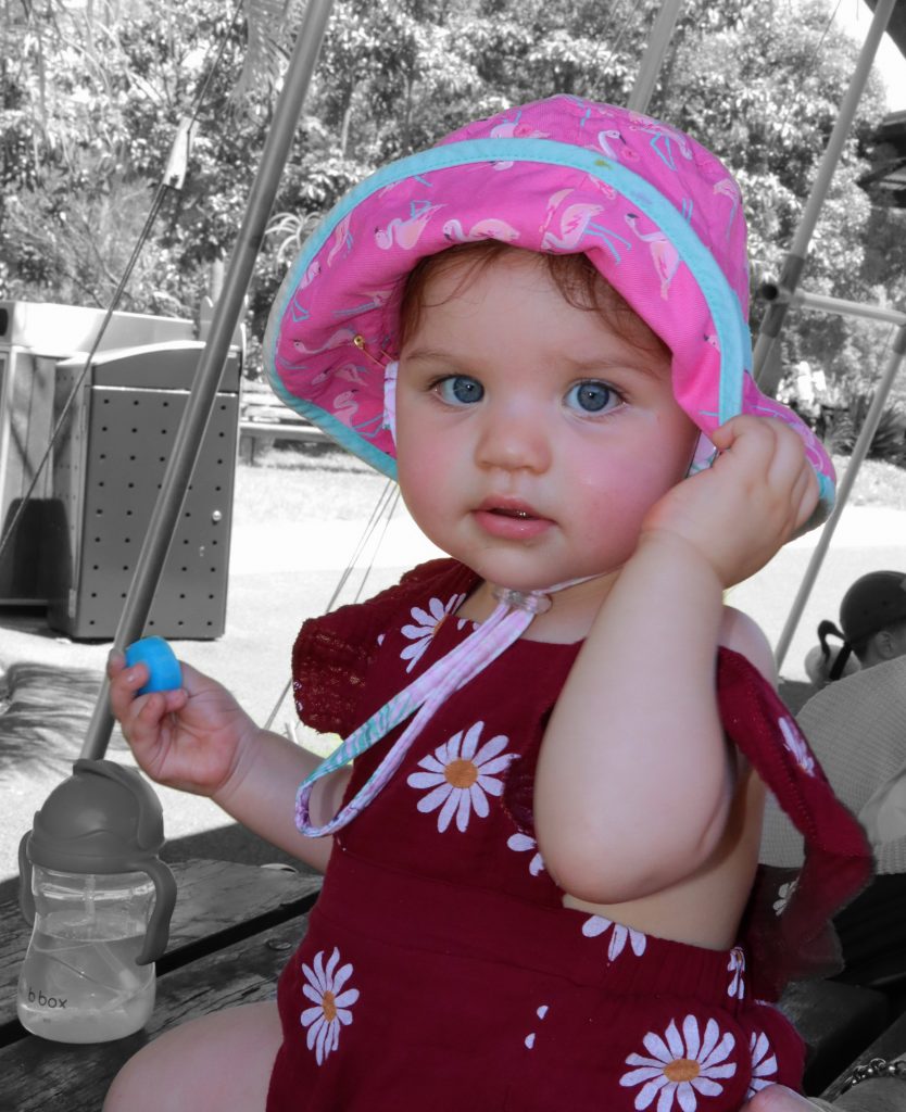 Photo of a baby girl in a hat by Brisbane family photographer, Matt Cornell